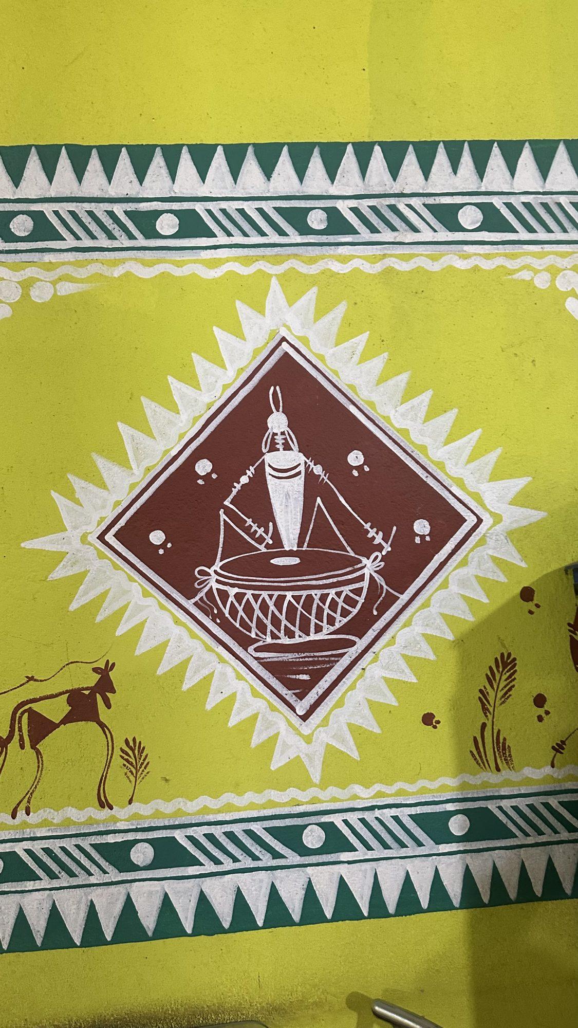 Folk-art wall painting of a large drum in a diamond frame